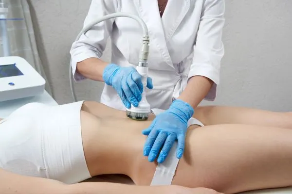 Lost the Weight but Not the Loose Skin? 2 woman having HIFU treatment on her stomach to combat loose skin Bellshill following weight loss